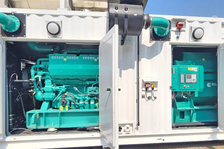 Cummins diesel generator set with its PowerCommand controller inside an open sound-attenuated container